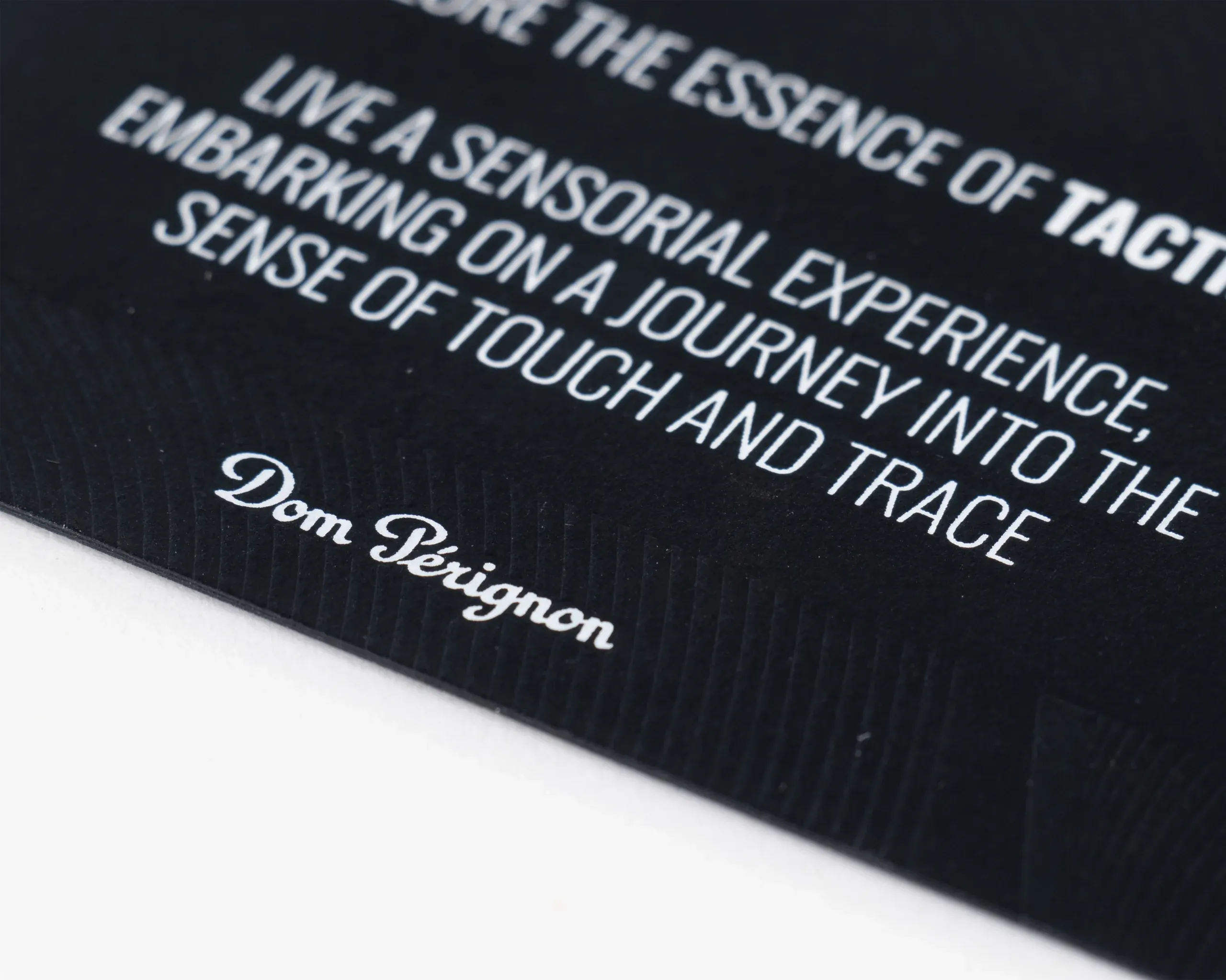 Detail of Dom Pérignon logo and tactile embossing on premium card