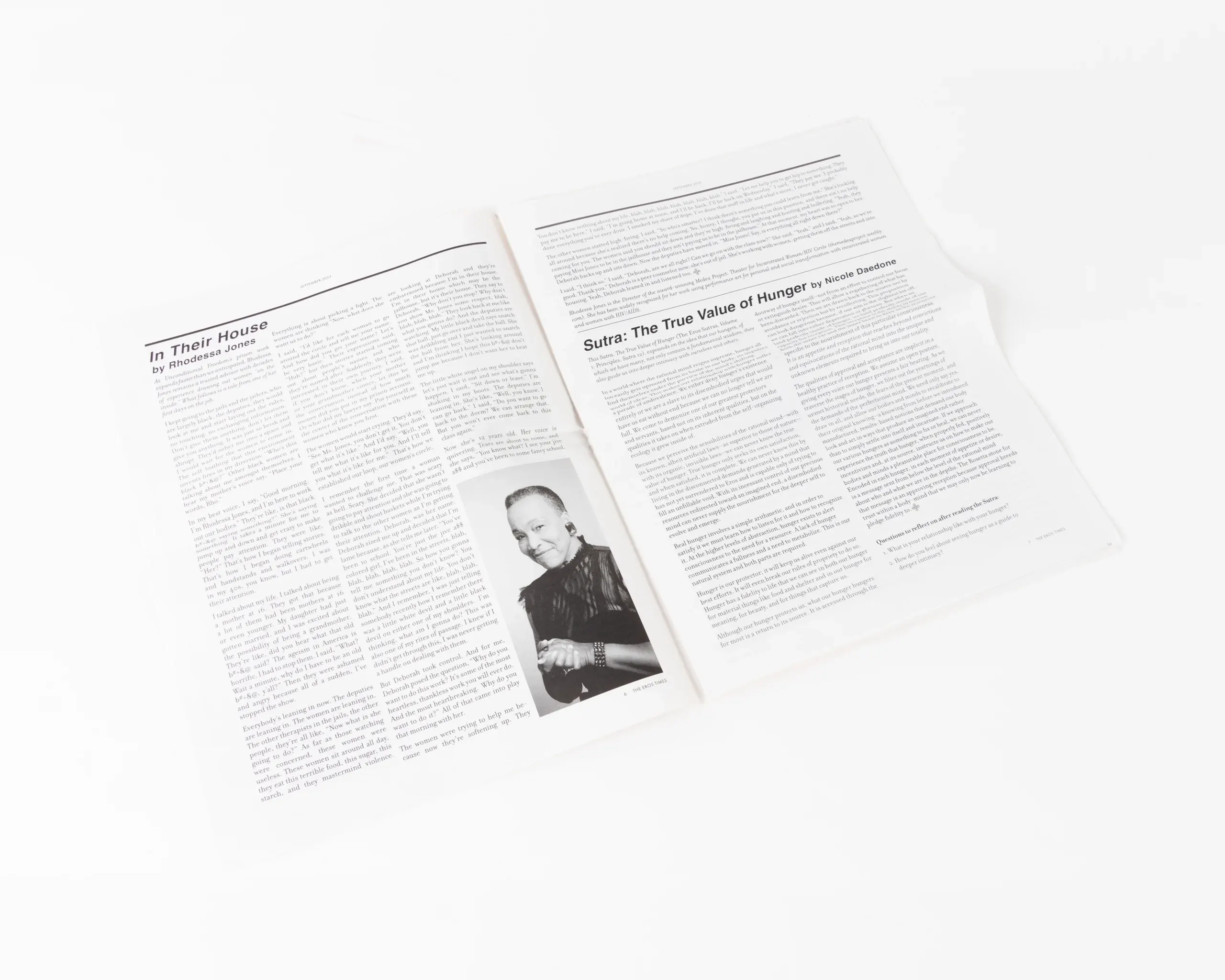 Open tabloid-style newspaper featuring large editorial headline design
