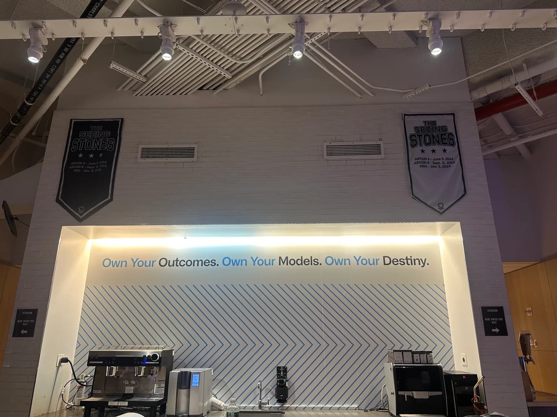 Wall graphics and hanging displays installed throughout a branded office space