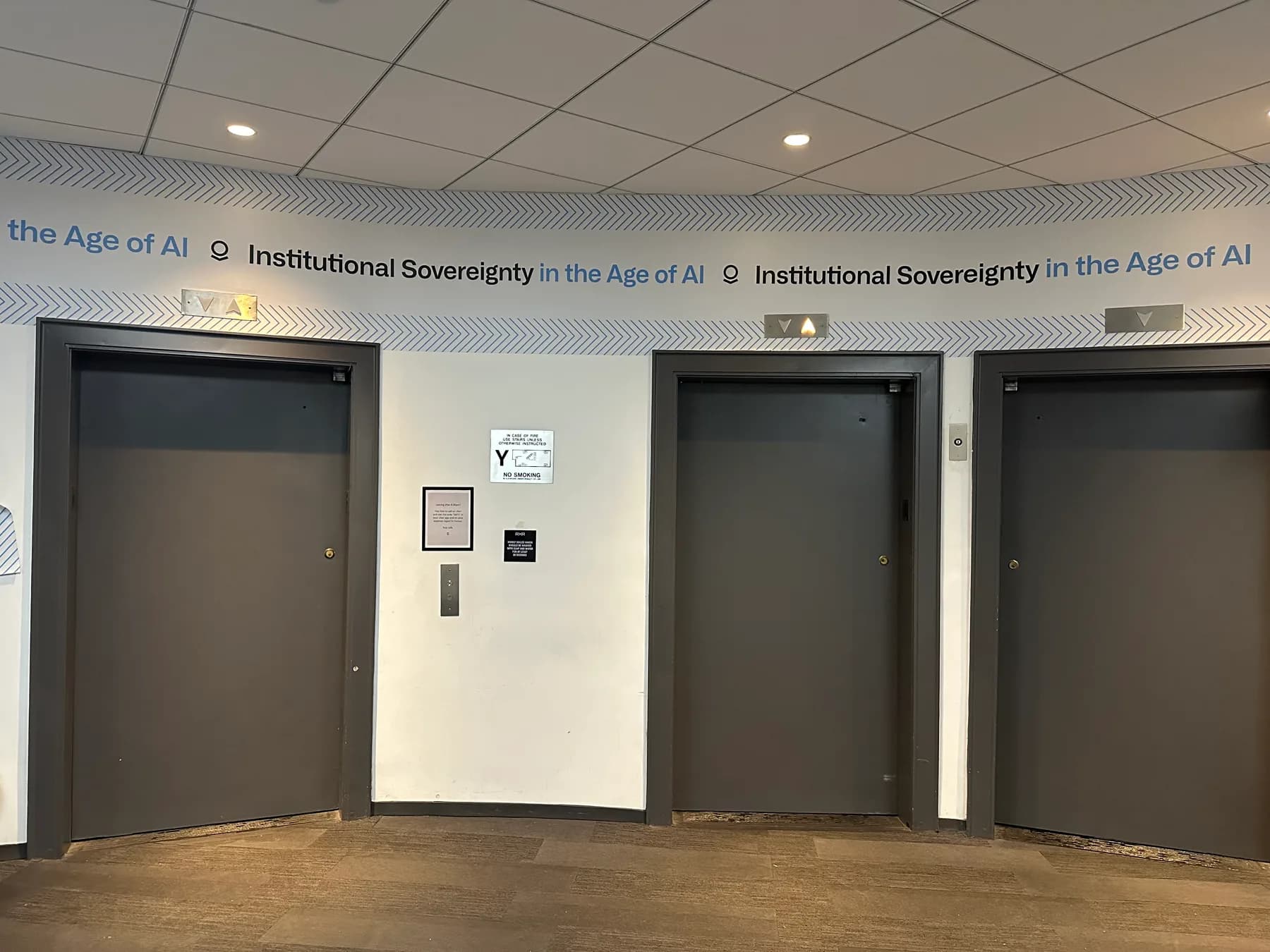 Wall graphics installed across an office elevator bank