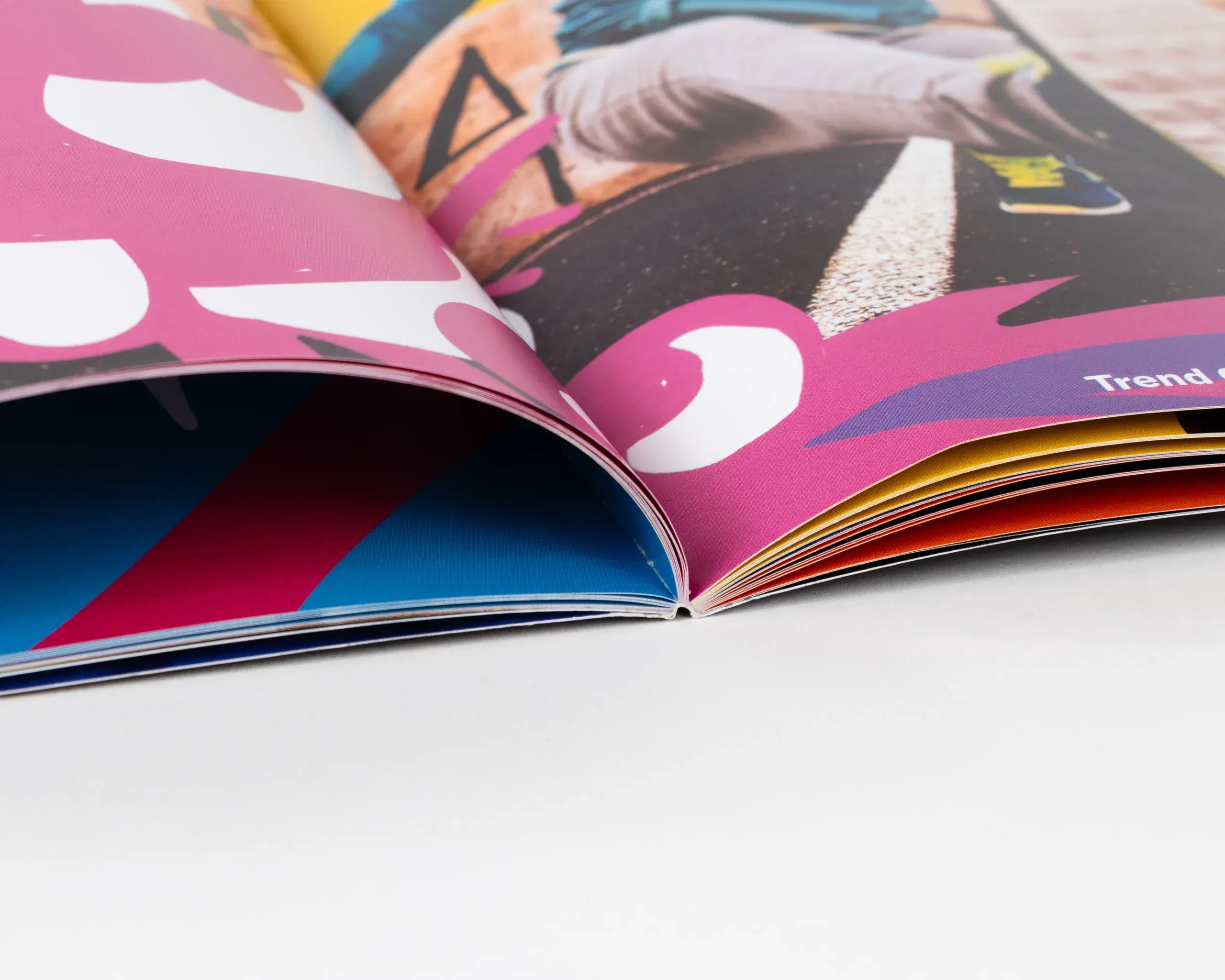 Close-up of perfect bound magazine spine and colorful printed pages