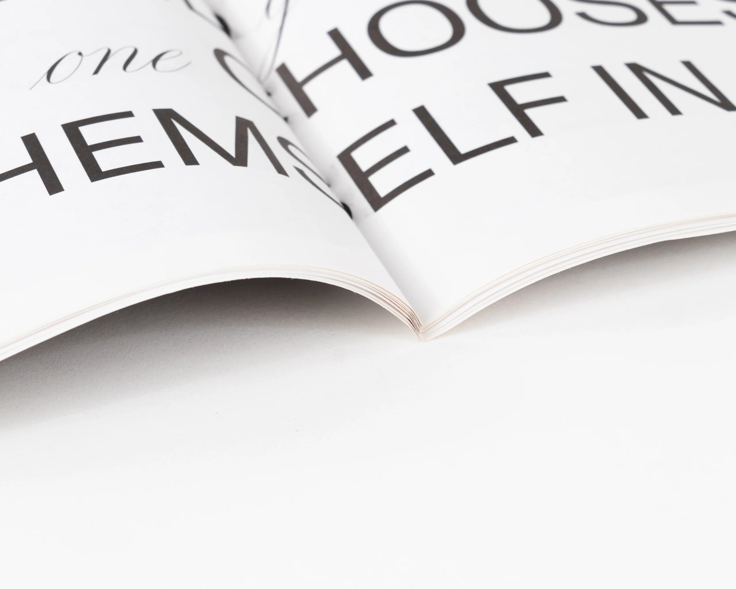 Close-up of saddle-stitched binding on uncoated lookbook pages