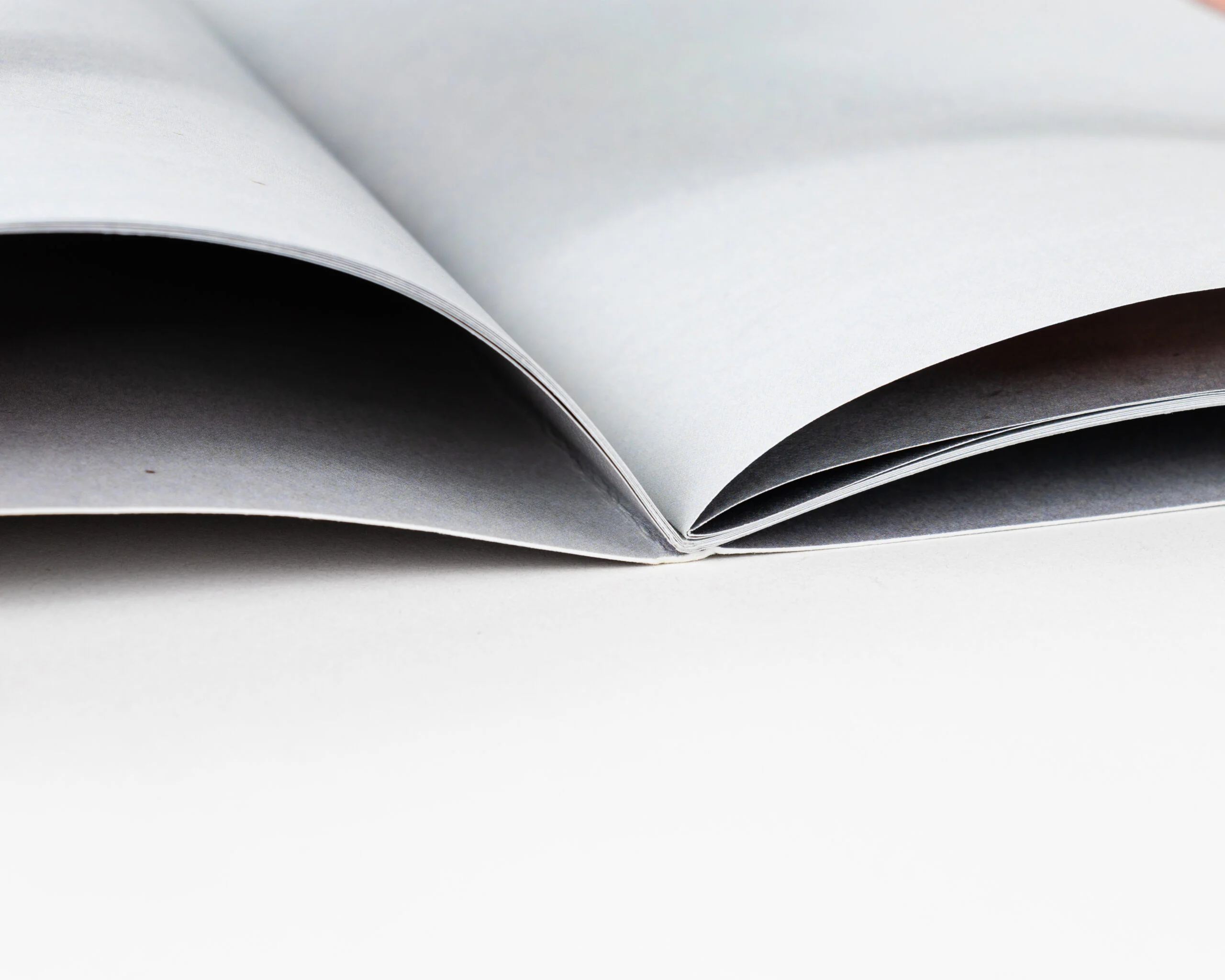 Saddle stitched look book spine detail on white background