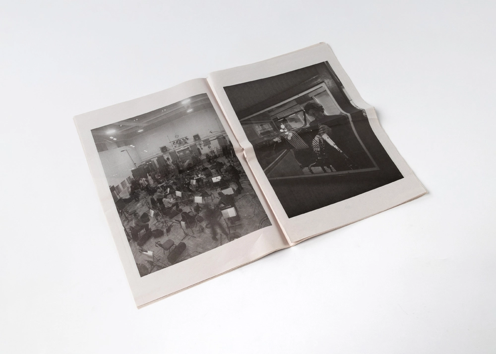 Open black-and-white broadsheet newspaper printed by Thomas Group Printing