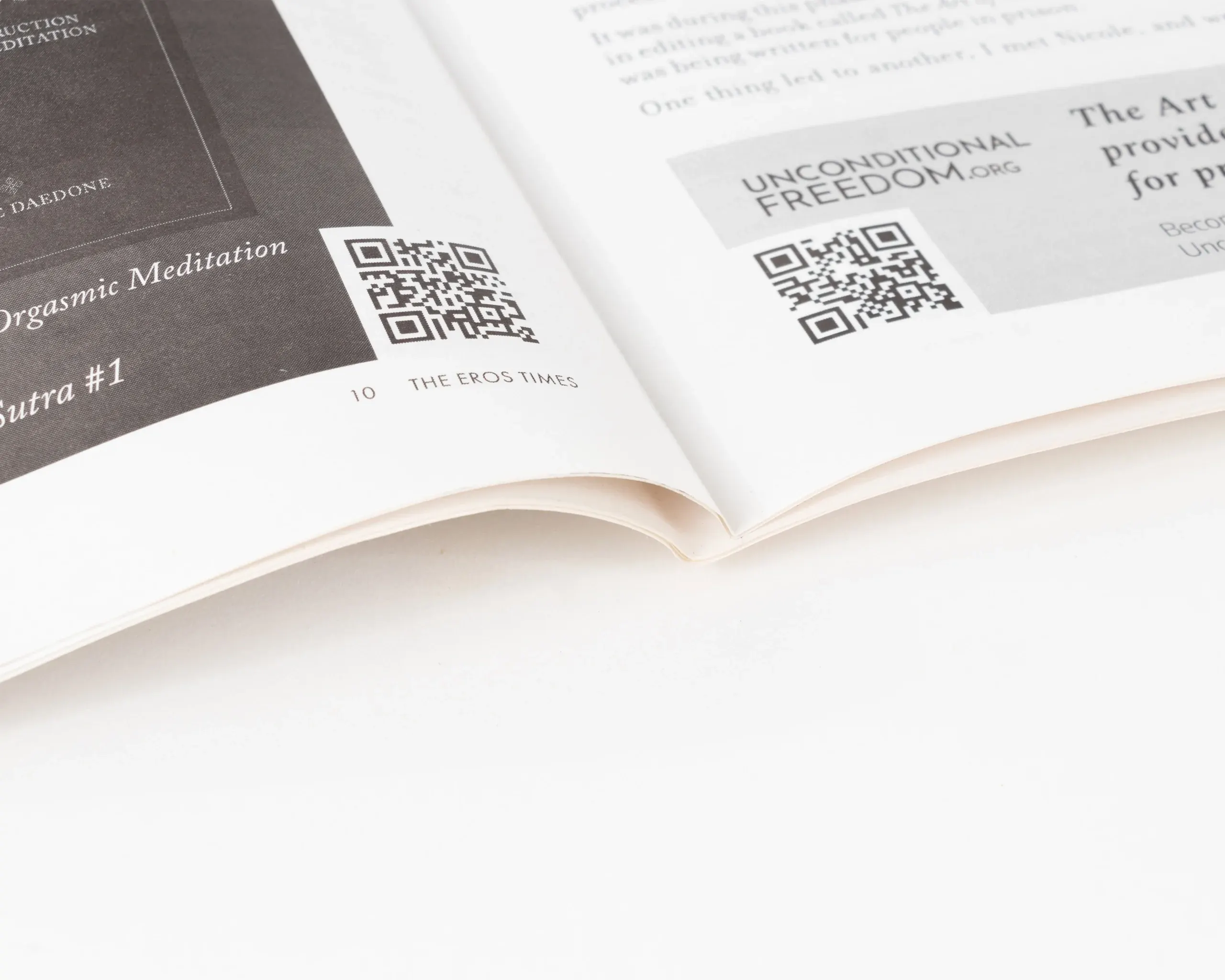Close-up of newspaper page corner showing QR codes and page details