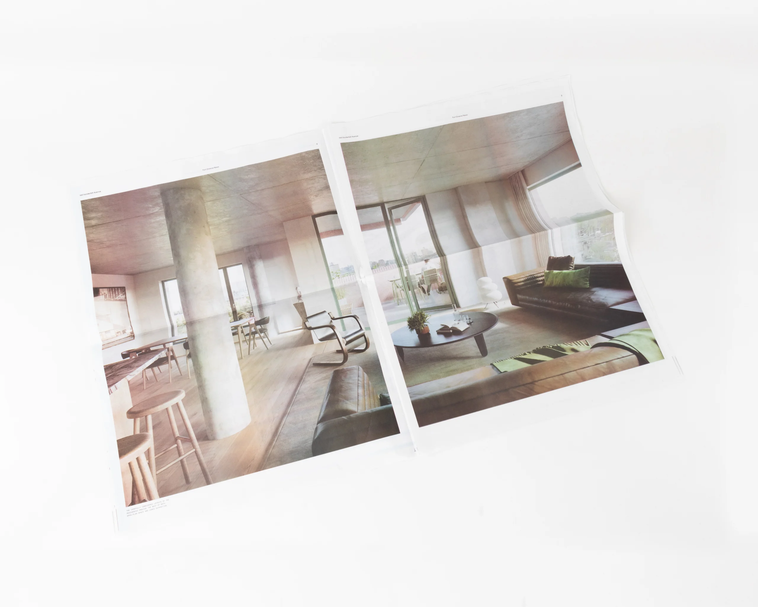 Close-up of real estate newsprint showing outdoor terrace and seating area printed on uncoated stock