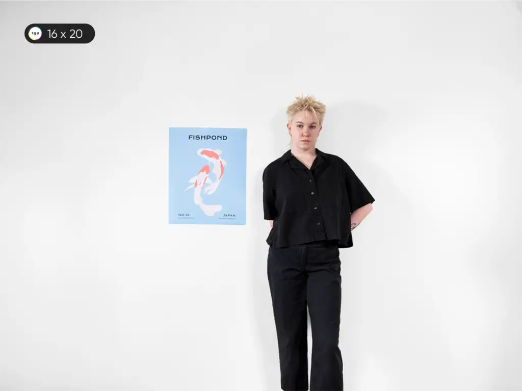 A model is displaying a 16 x 20 inches or A2 size poster known as the Photo Poster. The poster size is roughly the size of a medium artwork or large photo frame.