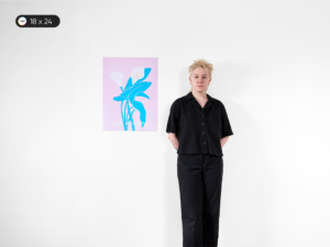 In this image, a model is displaying an 18 x 24 inches or B2 size poster, referred to as Medium Poster. This poster size is akin to a small poster commonly seen in home decor.