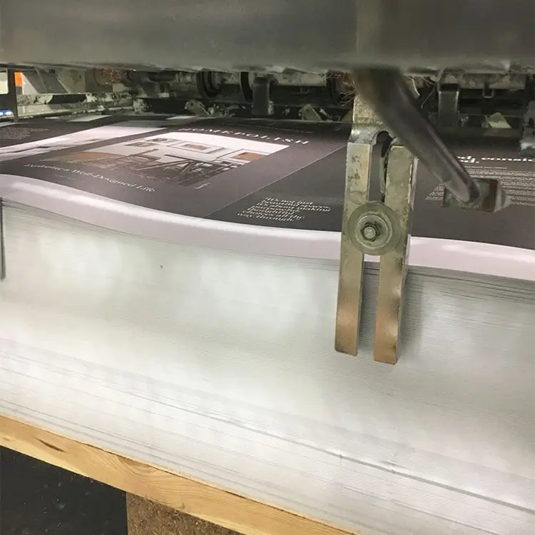 An offset printing job coming off of the press.